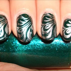 Futuristic Swirl Nails
More photos here: http://www.swatchandlearn.com/nail-art-silver-swirl-konadicure-using-mac-jade-dragon-china-glaze-millennium-konad-image-plate-m63/
