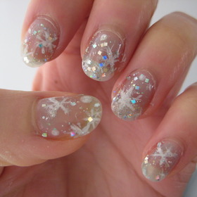 icy snowflake nails: pale blue flakes/glitter underneath, then snowflakes topped with microglitter, lastly a top coat with small and large glitters