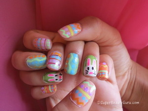 http://superbeautyguru.com/spring-makeup-using-analogous-colors-and-double-winged-liner
This Easter nail look uses pastel colors to create an adorable Easter egg and Easter bunny nail look. I used nail paint and striping tape along with nailpolish to do these nails, and have a video tutorial on my blog.