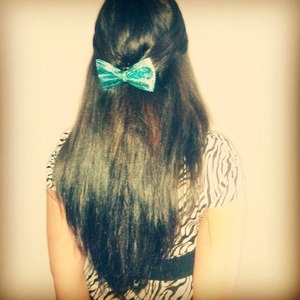 My somewhat long brown hair straightend and with a big beautiful blue bow (: 