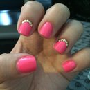 Neon pink nails with gold studs