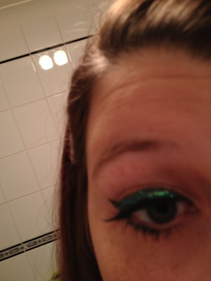 False eye lashes with green eye liner 