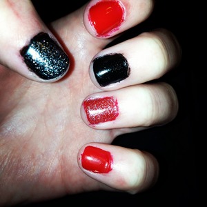 Red and black nail polish with glitter.