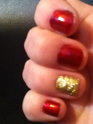 Red nails with a gold accent gives off a great holiday feel.
