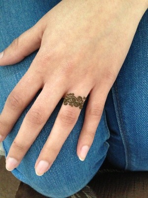 Small temporary indian tattoo on the ring finger. 