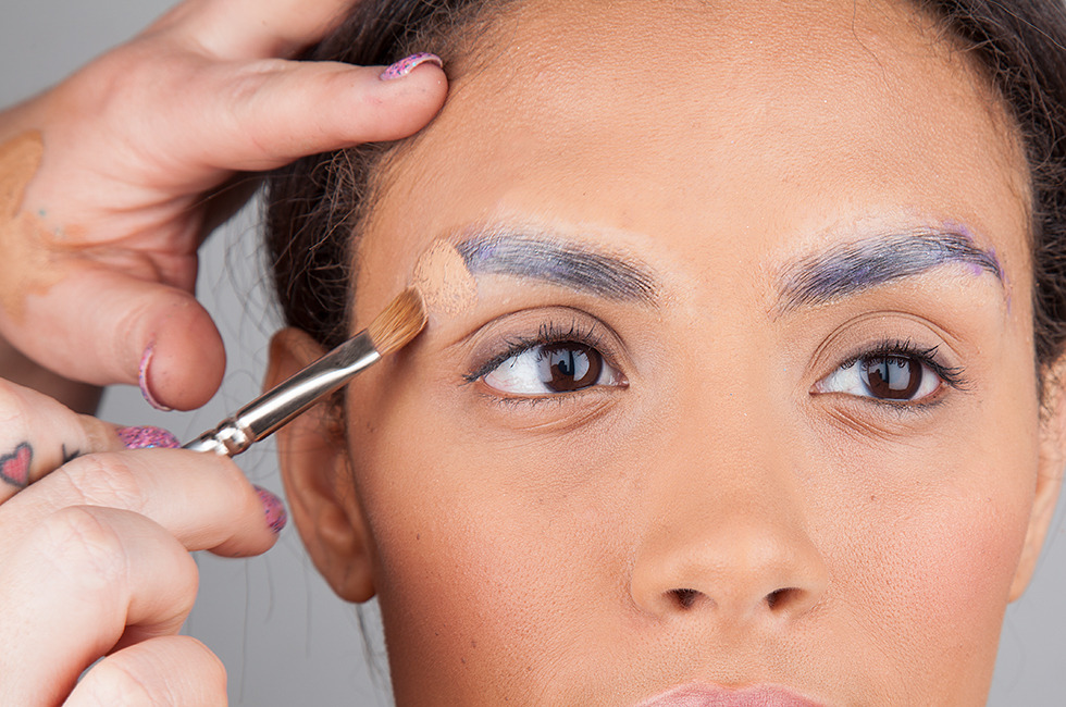 With a sturdy brush, dab concealer over the brows