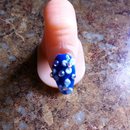 Blue acrylic nail with white flowers