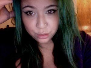cat eyes with taupe eye shadow and white high lights. light pink cheeks