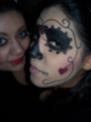 Halloween 2009-ish (lol) this is my sister- did a dia de los muertos look for her- used cream paint, red glitter and a khol eyeliner in black