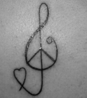 this tattoo is a peace signed musical note. it symbolises love of music and how music can help to create peace not just within you but within everybody<3x