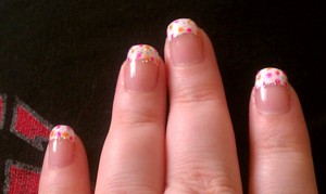 my  own  nail design  white tips  and orange and pink dots  with a  lil glitter polish 