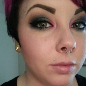 Dark smokey blue look with a pop of hot pink in the inner corners for fun.