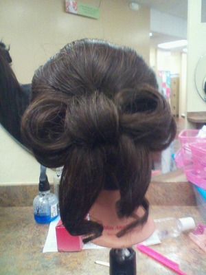 teased smoothed and curled into a beautiful bow updo