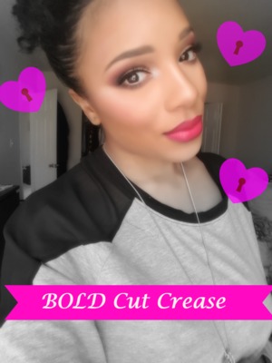 Bold pink cut creas with a blown out lower lash line andbold red lips