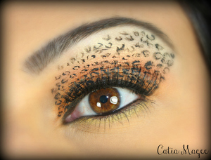 Leopard eyes!
Urban decay eyeshadow primer all over the lid,
Any orange color all over the lid 
Peachy pink color on the crease
gold shadow on the brow highlight.
Black pen eyeliner to make the parentheses all over the lid to brow to look like leopard spots.