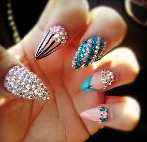 Aqua blue blinged out pointed nails
In love