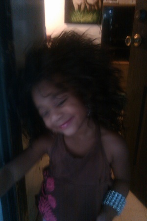Mya dressing up with my wigs at grannys house