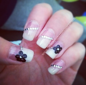 Diagonal cream french tips and rhinestone bordering, with some black flowers thrown in :)
