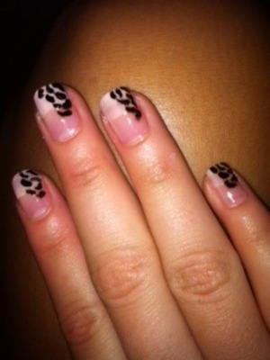 leopard printed nails with a light white tip.
