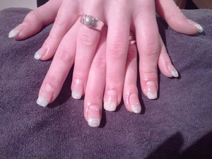 Normal French Manicure with a little glitter on it.
Acrylic nails at my cousin her nails.