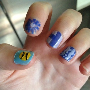 How To: Super Easy Tennis Nails!
1. Paint your nail solid blue. Let it dry. 
2. Put a large yellow dot in the center of your nail. Let it dry. 
3. Use a toothpick to make black lines 
4. Enjoy and show off these super fun nails!!!!
   