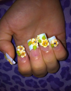 Orange and white flowers with stone in the middle. French tips 