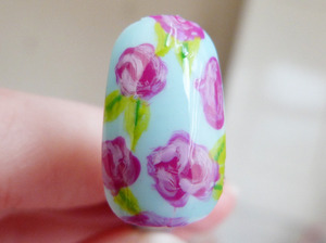 Floral roses painted on a false nail...
