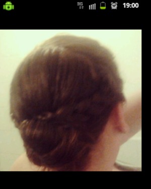 Short hair, braided sides over small bun in the nape of the head
