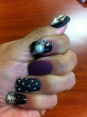 Combination of gems, glitter, velvet nail, and black matte .