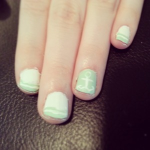Simple french striped tip with anchor decal on thumb and ring finger.