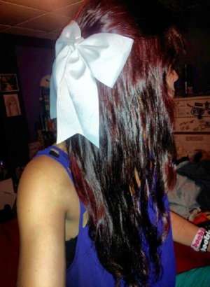 red hair, curled, top pulled back with bow 