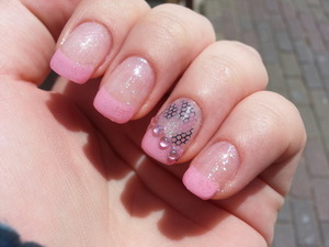 Light pink nail polish and stones with leopard lace