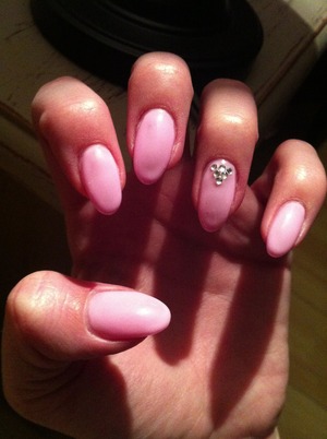 Gel nails in color pink with touch of diamonds.