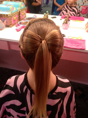 Hair bow with the rest of the ponytail hanging loose. 