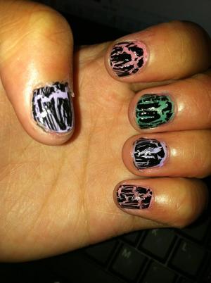 Purple, pink , and green as base color with crackle nail polish on top.