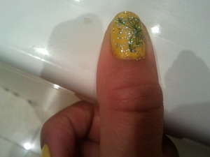pretty yellow polish, pretty blue butterfly  and glitter nail polish on top 