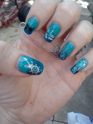 I did a fading effect with different blues and then some stamping. I did this nail for a contest and won :)