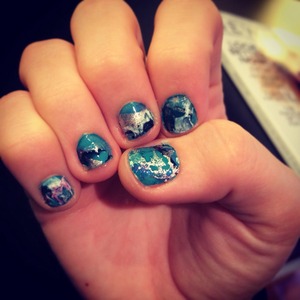 Galaxy nails created using various colors and the water marbling process. 