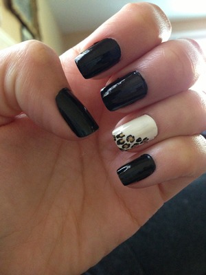 Black nails with a white base & a half cheetah print design 