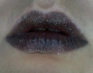 For when your inner goth digs black lipstick, but you don't like the severe look of it... I love this lipstick. Urban Decay lipstick in Oil Slick. It's a sheer silvery black that you can put on heavily or lightly for just a dark tint.