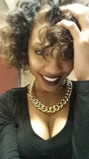 short curly hair style with dark purple lips 