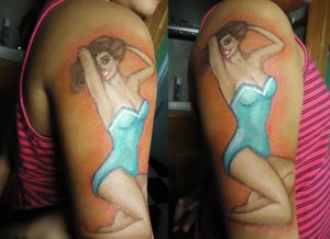 A pinup girl on my sister's arm that I did using all eye shadow and makeup medium.
