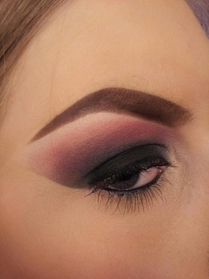 A bold, black smokey eye with orange and pink colors.