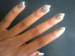 gold, black and white. stiletto nails, with edgy tips