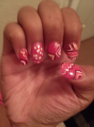 yellow white light pink and dark purple abstract tribal design on top of neon pink base polish.