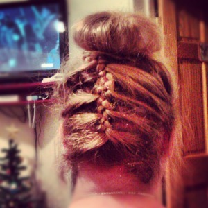 French braid on the back of the head and places around a sock bun. 