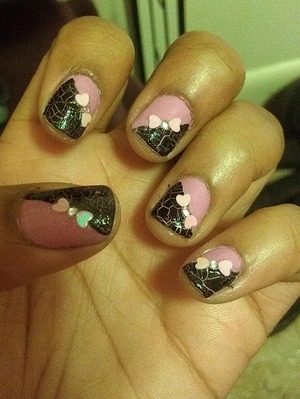 black crackle, over pink varnish. also added rhinestones and hearts to create bows.