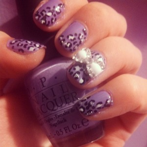 Purple nails with leopard print and a big shiny bow   ;) 