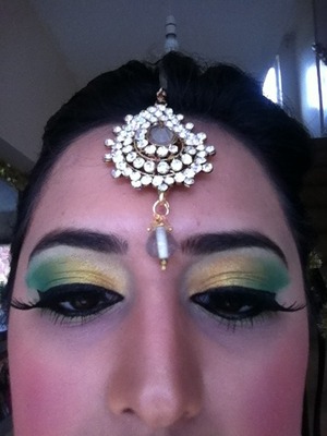 Yellow and green eyes with liner and false lashes. 