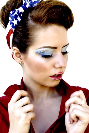 Blue starred eye shadow accompanied by red and white striped lips.